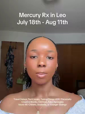 A selfie-style video cover image featuring a Black woman centered in the frame, looking directly at the camera. She has smooth skin, minimal makeup with flushed cheeks, and small gold hoop earrings. The image is well-lit, with a warm, natural light. Behind her, a neutral background is visible, hinting at an interior setting. Text overlays are added at the top and bottom, with the top text focused on a Mercury retrograde astrology update and the dates, and the bottom text is a list of potential issues for people facing this time.