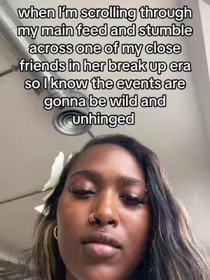 The cover image shows a close-up of a Black woman's face. She has dark hair, styled with a white flower accessory. She has several facial piercings, including a nose ring and a lip piercing. The background is a light-colored, plain ceiling.
