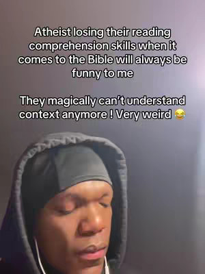 A close-up shot of a Black man wearing a black durag and hoodie, against a blurred grey background. The man has a serious, slightly downward gaze. Above him is overlaid text in a rectangular format. The text starts with a statement about atheists' reading comprehension and ends with a humoristic statement. The overall composition is straightforward, emphasizing the man's expression and the message.