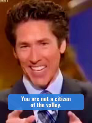 A medium shot of a man with short, brown, wavy hair. He has a warm smile and is wearing a dark suit with a patterned tie. A blue rectangular text box at the bottom has the words 'You are not a citizen of the valley.'