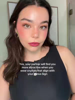 A woman with dark hair and makeup is posing, looking directly at the camera. Text is overlaid, discussing astrology signs.