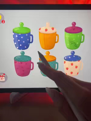 The cover image shows a person's hand holding a stylus and interacting with a tablet or similar device. The screen of the device displays an illustration of six different coffee mugs or cups. Each cup has a unique design and color scheme, along with lids. The overall style is colorful.