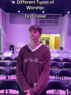 A young man stands in a church setting, facing forward with a serious expression. He's wearing a dark burgundy sweater and is surrounded by rows of empty chairs. Above him, text describes different types of worship.