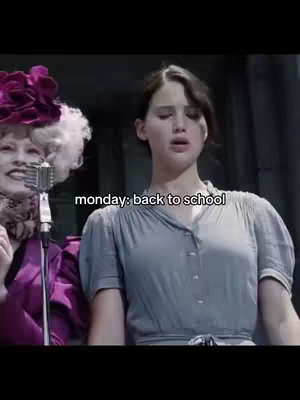 The cover image is a still from a movie scene with the text overlay of 'monday: back to school'. Two women are in the frame, one in the right foreground with a shocked expression likely in the middle of speaking and another on the left covered in makeup. The background is a dark, indoor setting.