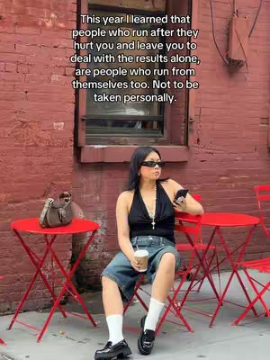 A woman is seated at a red table, wearing sunglasses and casual attire.  Text overlayed over an out of focus outdoor setting that includes brick.  She is holding a coffee cup, and a cell phone while looking at it.