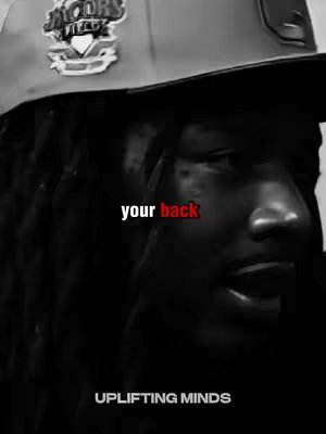 The cover image is a black and white, close-up portrait of a man with dreadlocks wearing a baseball cap. The man's face is angled slightly, and he appears to be looking off to the side. Text in white and red reading "your back" is superimposed over the image with the words "UPLIFTING MINDS" in white at the bottom..