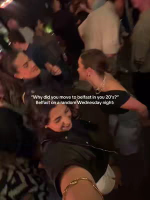 The cover image shows a crowded nightclub scene with two young women in focus. The woman facing the camera is smiling, while another woman leans in towards her, appearing to be mid-conversation. The background is blurred, filled with other people in the club. The colors are dim and warm due to the interior lighting.