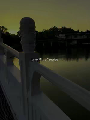 A scenic shot at dusk with a bridge in the foreground and a body of water reflecting the sky. The golden-hour light casts a warm glow, silhouetting trees and structures in the distance. Text overlay in white is added on the foreground.