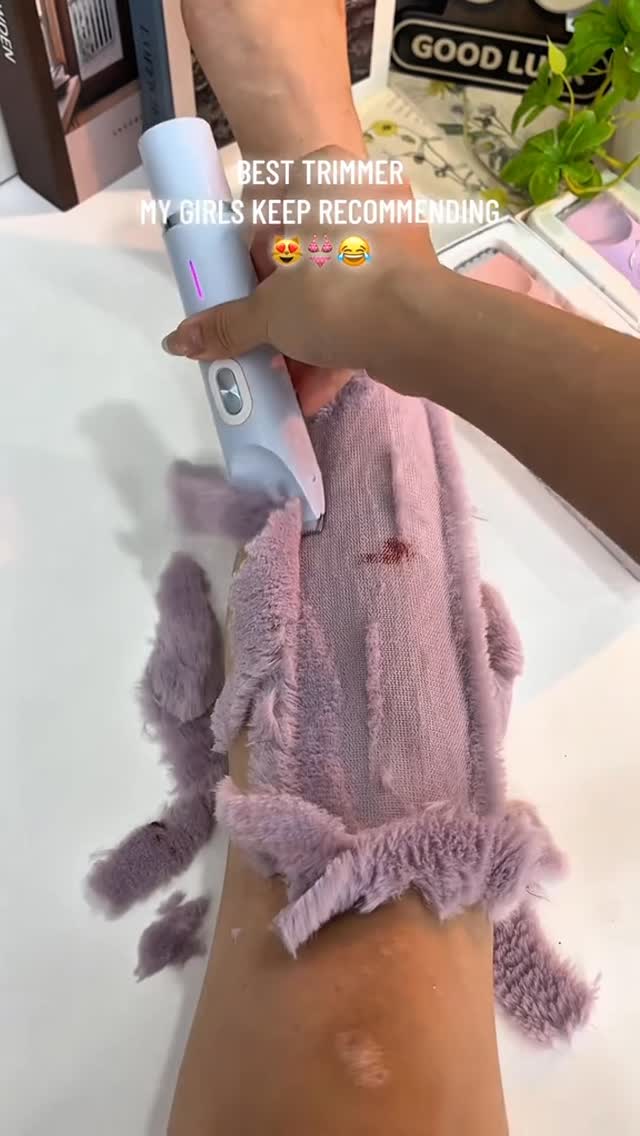 The cover image shows a close-up of a person's arm with a gray electric razor being used to trim the fur of a lavender-colored fabric that's covering their forearm. The phrase "BEST TRIMMER" is above the person's arm, and the text "MY GIRLS KEEP RECOMMENDING" is a bit lower down. There are several white objects in the background.