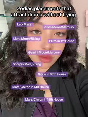 A selfie-style image featuring a person looking directly at the camera. The individual has dark hair and is wearing makeup. Overlaid on the image are purple rectangular labels with white text, each indicating a different astrological placement. The background is blurred, suggesting an indoor setting, and overall the image uses a cool color palette with purples and blacks.