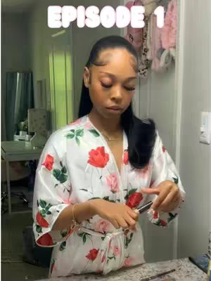 A young woman with dark hair and a floral robe is shown in a close-up shot, likely in a bathroom, looking down. The text overlay 'EPISODE 1' appears in a bubbly font at the top of the image.