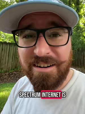 A man with a beard, glasses, and a hat is positioned in front of a blurred green background. The man is centered, dominating the frame with a close-up shot that emphasizes his facial features and a text overlay indicating the subject of the video.