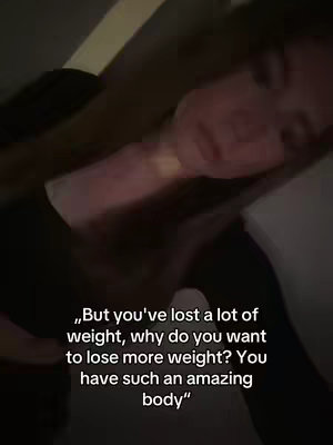 The image shows a woman lying down, possibly in bed. The lighting is dim, and a text overlay poses a question about weight loss and expresses admiration for her body. The composition is intimate with the woman's face close-up.