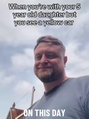 A man with a beard and a gray shirt smiles at the camera against a cloudy sky background. Text overlays the image.