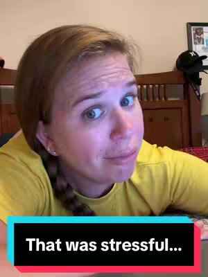 The cover image shows a woman in a close-up shot, looking towards the left with a slightly concerned expression. She has light skin, blonde hair pulled back into a side braid, and is wearing a yellow shirt. In the background, portions of a wooden headboard and a framed picture are visible, suggesting a bedroom setting. A text overlay at the bottom reads, "That was stressful..."
