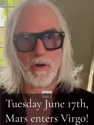 A man with long, gray hair and sunglasses speaks directly to the camera, with text overlayed on the bottom.