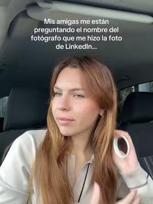 A woman is sitting in a car, turned slightly towards the camera, seemingly talking. Text overlayed on the image asks about a photographer who took a LinkedIn photo. The car interior is visible, suggesting a casual, personal setting.