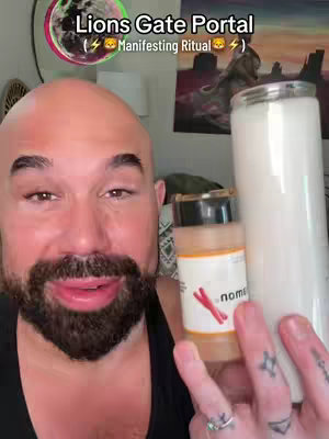 A man with a bald head and a beard is holding a white candle and a bottle with a label, with text overlayed on the image. A colorful planet is in the upper left corner of the screen.