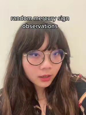 A medium shot of a young woman with long, dark hair and round glasses. She is looking towards the camera with a neutral expression. Overlayed text indicates the video's theme.