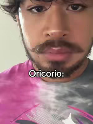 A close-up shot of a man's face who is wearing a pink and tie dye shirt, with the overlay saying "Oricorio:"