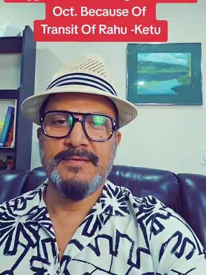 A man wearing a fedora, glasses, and a patterned shirt is centered in the frame. Text overlayed in a rectangular box at the top reads, "Oct. Because Of Transit Of Rahu - Ketu" in capital letters. Behind him, a shelf with books and a framed picture are visible, indicating an indoor setting.