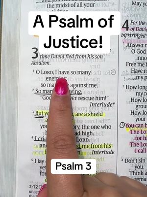 A close-up shot of a Bible open to Psalm 3. A finger with pink nail polish points towards highlighted text. White rectangular text boxes overlay the image, reading: A Psalm of Justice! and Psalm 3.