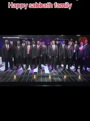 The cover image shows a group of men in suits standing in front of a stage, with text overlayed at the top. The men, likely a choir, are the central focus, set against a backdrop that fades to black towards the top and bottom. The lighting seems to be stage lighting.