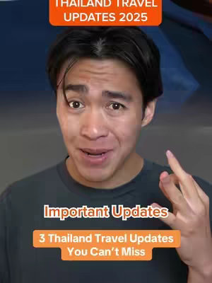 A man with dark hair and a gray t-shirt is looking towards the camera with a surprised expression and finger-pointing gesture. The image features three text overlays: “Thailand Travel Updates 2025” at the top in an orange rectangular box, “Important Updates” and “3 Thailand Travel Updates You Can’t Miss” in an orange box in the middle. The background is a blurred sky with an indistinct landscape.
