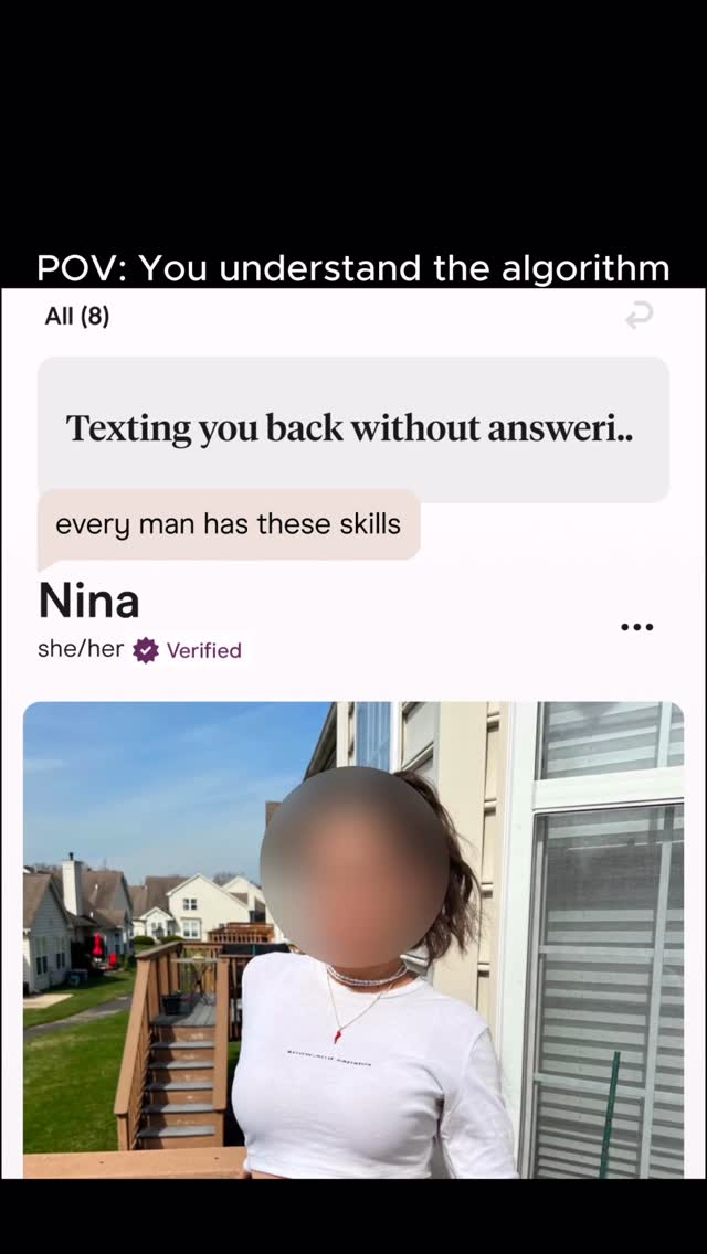 A photo of a person whose face is blurred standing on a wooden deck. In the background are houses and trees. A white text box overlays the image, reading:  "Texting you back without answeri.."
Below that, another text box says: "every man has these skills"
Under that text is the name "Nina", with the words "she/her" and a verified badge.