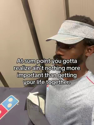 A man wearing a visor poses for a selfie with motivational text overlaid. He is in a gray shirt and the background is neutral.