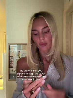 A woman with long blonde hair is looking down and slightly to the side. Text overlayed on image reads: Be grateful that you slipped through the hands of those who had no idea how to hold you.
