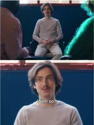The image is a split-screen shot. The top half shows two men in a well-lit room. One is seated and looks directly at the camera; the other is partially visible from behind and to the left. The bottom has a close-up on the first man, with text overlayed at the bottom.
