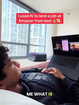 The cover image shows a person lying in bed, looking at a laptop. On the laptop screen, there's a video call interface with two other people. A red rectangular text overlay at the top says, 'I used AI to land a job at Amazon from bed.' The overall composition suggests a comfortable and modern setting within an apartment.