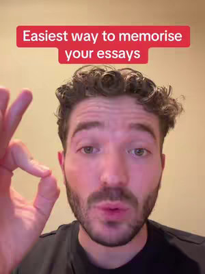 A man with a beard is shown in a close-up shot, making an OK sign with his left hand, with the text overlaying a red box.