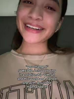 The cover image features a close-up shot of a smiling young woman. She has light skin, dark hair pulled back, and is wearing a light-colored sweater. Her eyes are visible and her mouth is open in a smile, with some blemishes. Below her, text overlaid reads a personal statement about a life change.