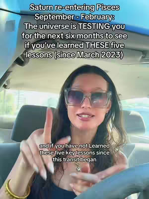 A woman is seated inside a car, likely filming a video. She wears large, square-framed sunglasses and is pointing with one finger. Text overlays on the image provide context, discussing Saturn's re-entry into Pisces and a related challenge for viewers. The background is of car parts and windows, indicating an indoor setting.