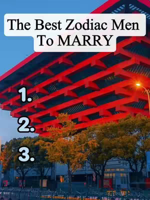 The image shows a large, red architectural structure with a complex, angular design, possibly a modern building. In the foreground, there are trees and some greenery, with an urban setting in the background. The sky is clear and blue. The overall composition of the image, with the vivid red of the structure, suggests a modern and possibly artistic or cultural setting, with the numbered labels highlighting the content.