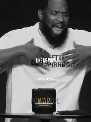 A black-and-white image featuring a Black man speaking with his hands gestures, with text overlays. A small device is on display, with text near it. The background is a dark studio setting.