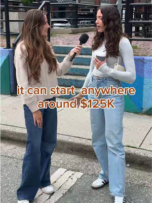 Two young women stand on a city sidewalk interviewing each other. The woman on the right is holding a coffee cup. The text overlay reads: it can start anywhere around $125K.