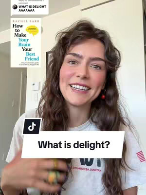A woman with long, wavy brown hair smiles at the camera, with a book titled "How to Make Your Brain Your Best Friend" visible in the background. A TikTok banner overlays the bottom, asking "What is delight?"