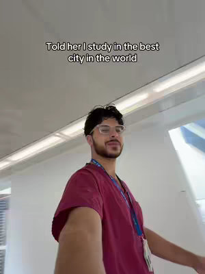 The cover image shows a man in scrubs looking at the camera, likely taking a selfie. The background suggests an interior place filled with white walls, and some glass windows. The person is wearing glasses and has a beard.