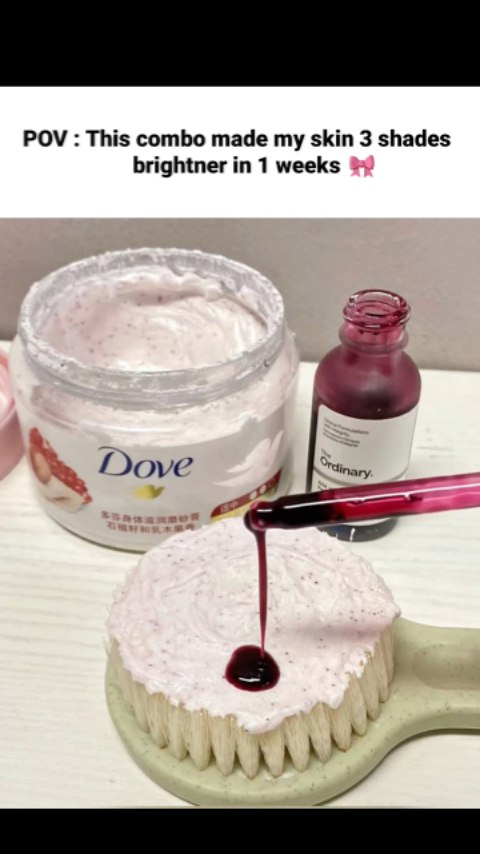 The image showcases a skincare routine with two products. On the left, is a jar of Dove body scrub, and ordinary bottle with products being poured onto a white brush. The combination creates a visually appealing setup. The background appears clean, and the lighting highlights the product.