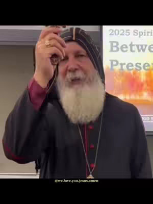 The cover image features a man with a long white beard, wearing a black and red religious garment and head covering. He is holding a string of beads in his right hand. Behind him is a screen with text that reads '2025 Spirit'. The background is a neutral color. The overall composition is a medium shot, focusing on the man and his religious attire.