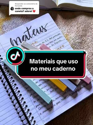 The image shows a notebook open to a page with the handwritten word "Mateus" at the top. Below, lines of handwritten text fill the pages. Five colorful highlighters are laid across the notebook pages, and a TikTok logo is overlaid with text that reads "Materiais que uso no meu caderno".