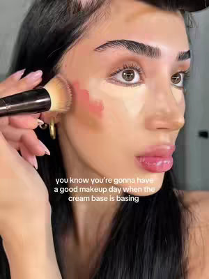 A close-up shot focuses on a person's face as they apply makeup. Patches of base makeup are visible on the face. The text overlay highlights the importance of good makeup application.