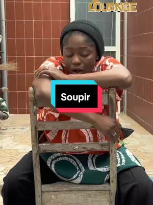 A woman with a black beanie sits on a wooden chair, leaning forward with her arms crossed. She's in a red printed top with hints of white and brown. The background is a brown-tiled wall and a white door that reveals a glimpse of an open hallway. At the top right part of the image, a logo in white lettering can be noticed. The hook text is in the form of an opaque box in the center, in the color that combines black white and red.