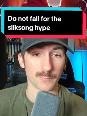 A man with a mustache, wearing a black cap and a green shirt, is looking at the camera with a red and black text overlay that reads, "Do not fall for the silskong hype."