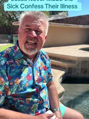 A man with gray hair and a beard is smiling at the camera, wearing a colorful shirt. The background shows a stone structure and water.