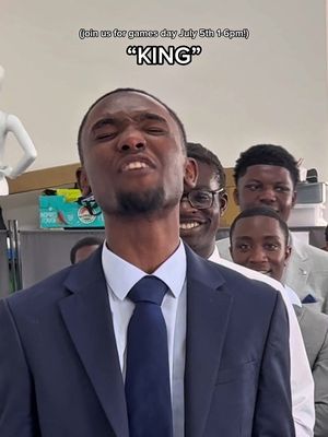 The cover image shows a group of young men in suits, with one man in the forefront making a funny face looking up with a slight grimace and closed eyes. The text overlay includes details regarding the games day. The background appears to be a lightly colored wall.