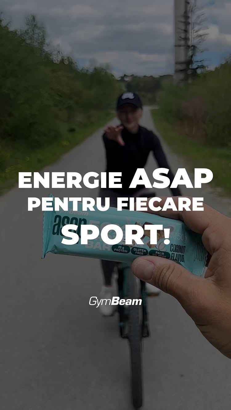 The cover image for the video is a shot featuring a person on a bicycle, holding out a snack bar towards the camera. The cyclist is seen from the back, blurred with the background, which looks like a road through a green area. The foreground shows the snack bar in the person's hand, partially obscuring the view, with accompanying white text. Overall, the image uses colors of green, blue and white that likely represent the brand and nutrition.